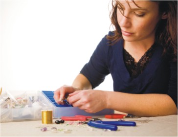 woman making jewelry